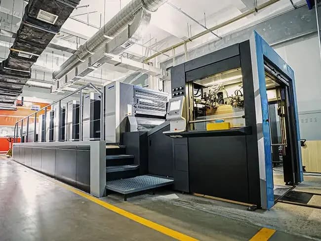 Industrial offset printing press on the ProPac production floor.