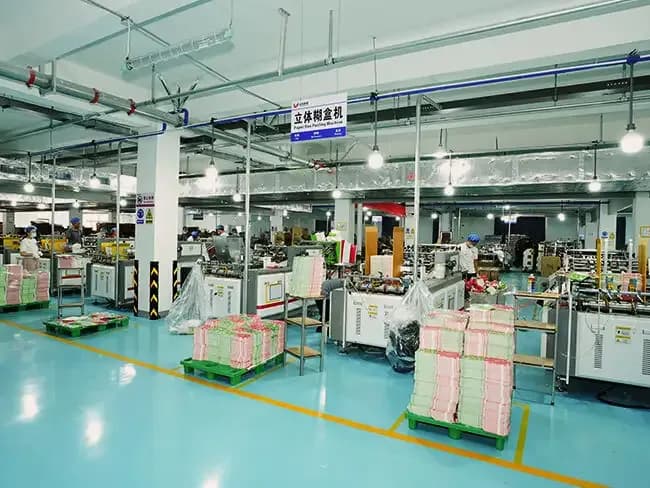 Paper roll feed system and automated packaging machinery.